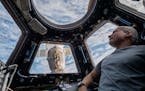 In this photo provided by NASA, astronaut Mark Vande Hei peers at the Earth below. Vande Hei is expected to return to Earth on Wednesday aboard a Russ