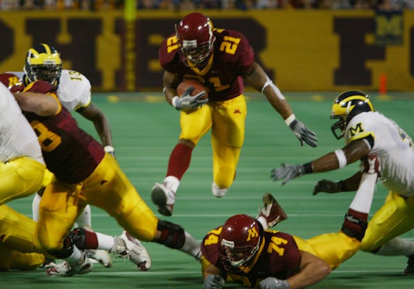 Minneapolis, MN - October 10 - MN Gophers vs Michigan - Marion Barber jumps through a hole on his way to score the first Gopher TD. ORG XMIT: MIN20131