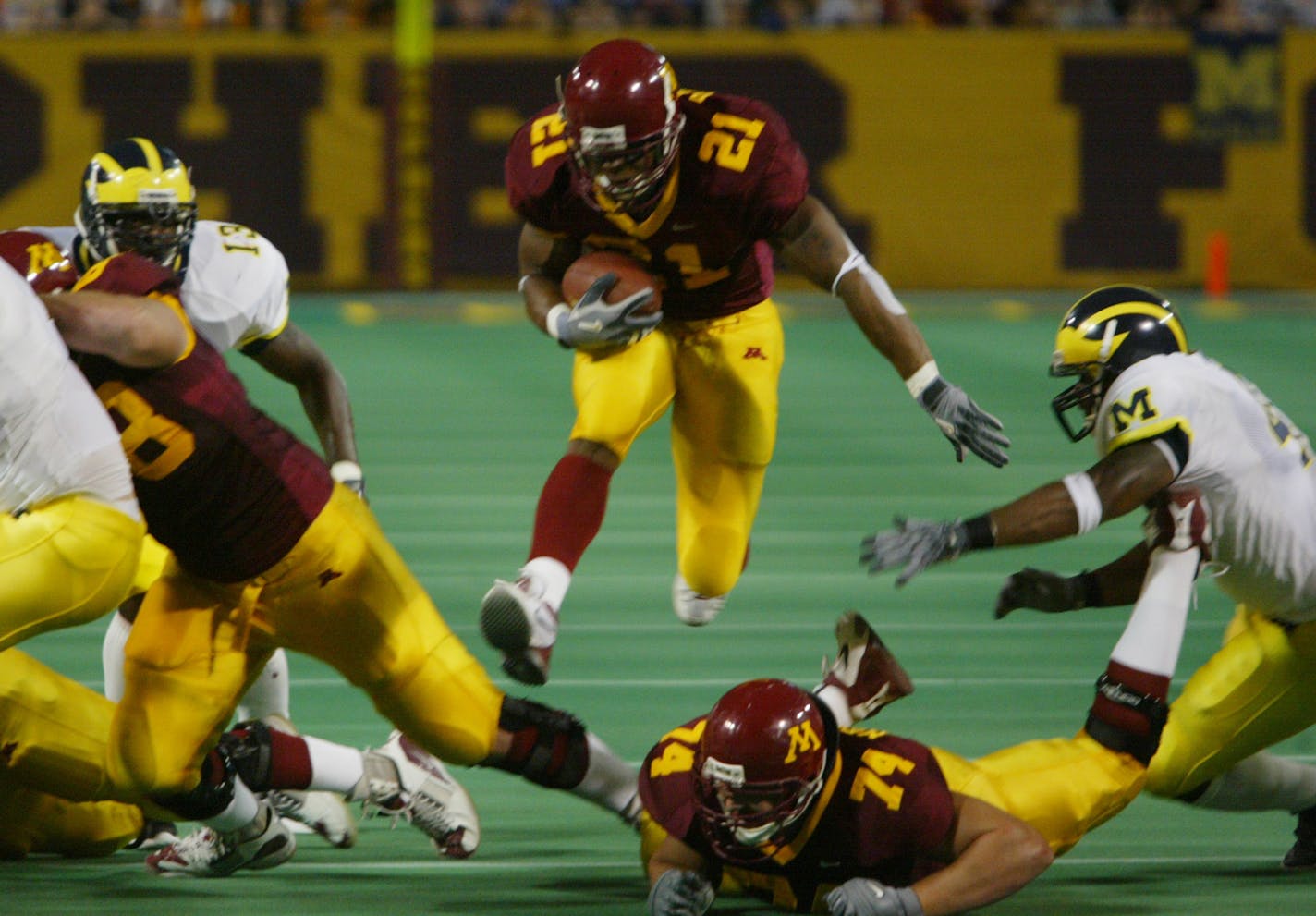 Minneapolis, MN - October 10 - MN Gophers vs Michigan - Marion Barber jumps through a hole on his way to score the first Gopher TD. ORG XMIT: MIN2013100121370109