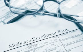 Medicare enrollment form and glasses. istock