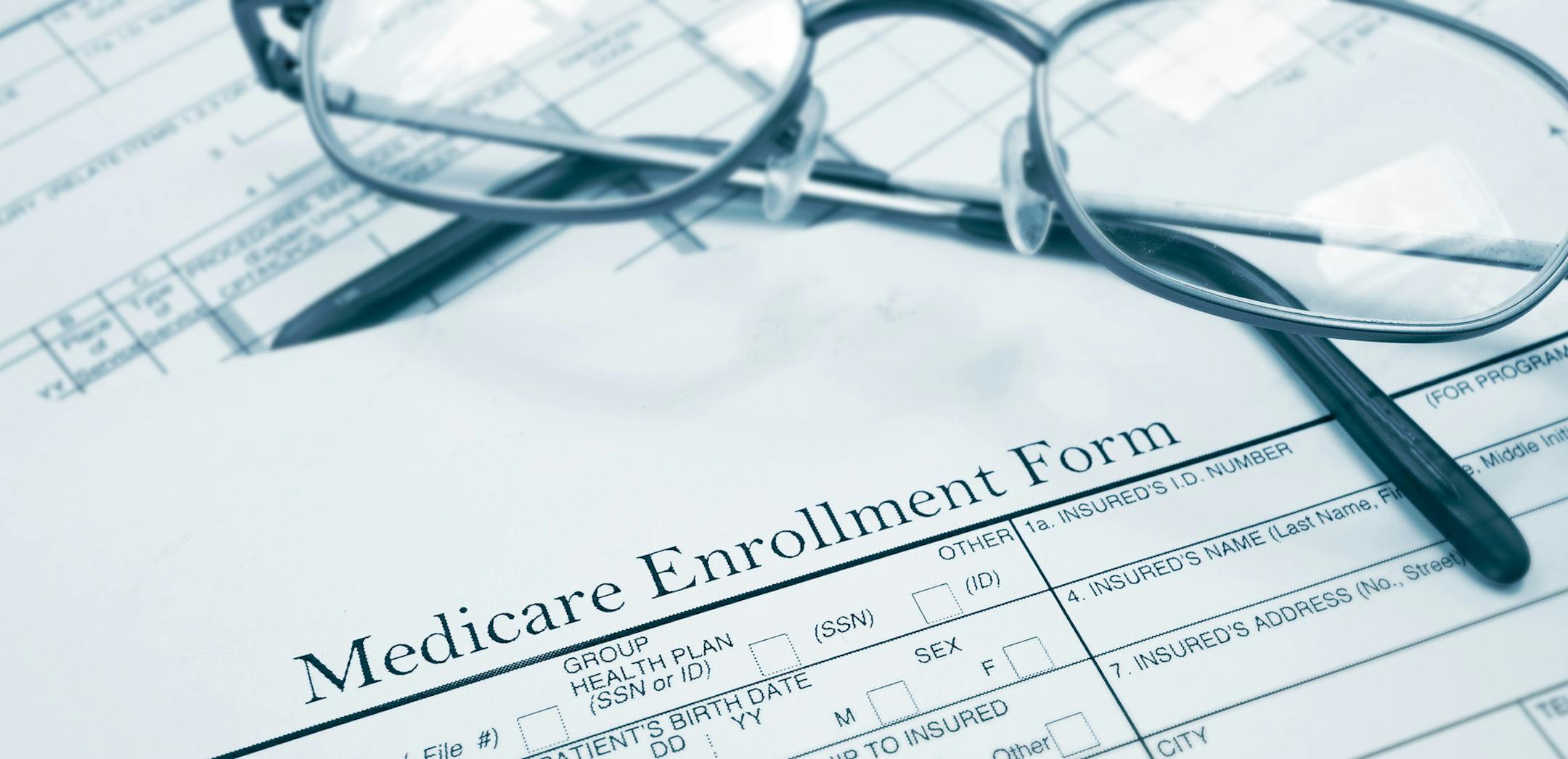 Medicare enrollment form and glasses. istock