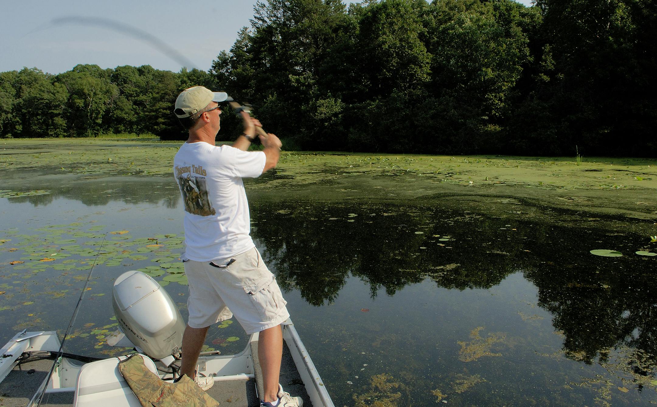 DO NOT USE! ONE-TIME USE WITH BILL MARCHEL COPY ONLY. Photo by Bill Marchel. Note the fishing rod is full "loaded" using wrist action instead of a throwing motion. This method will achieve longer casts, important when fishing bass in shallow water.