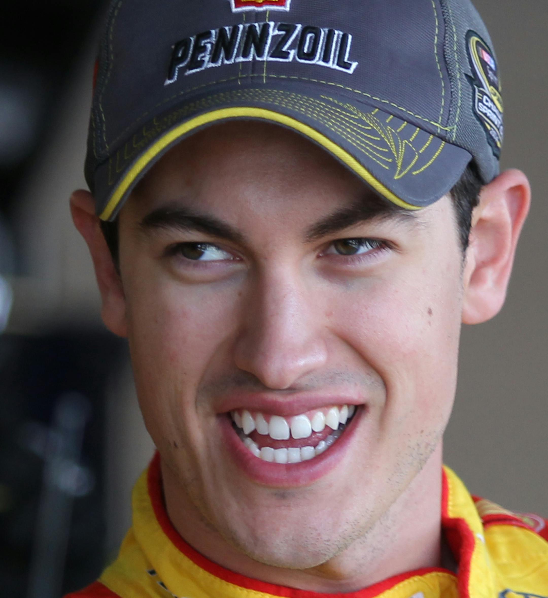 NASCAR auto racing driver Joey Logano gets into his car a he prepares for a practice round for the Sprint Cup Series Hollywood Casino 400 auto race at Kansas Speedway, Saturday, Oct. 4, 2014, in Kansas City, Kan. (AP Photo/Ed Zurga) ORG XMIT: KSEZ104