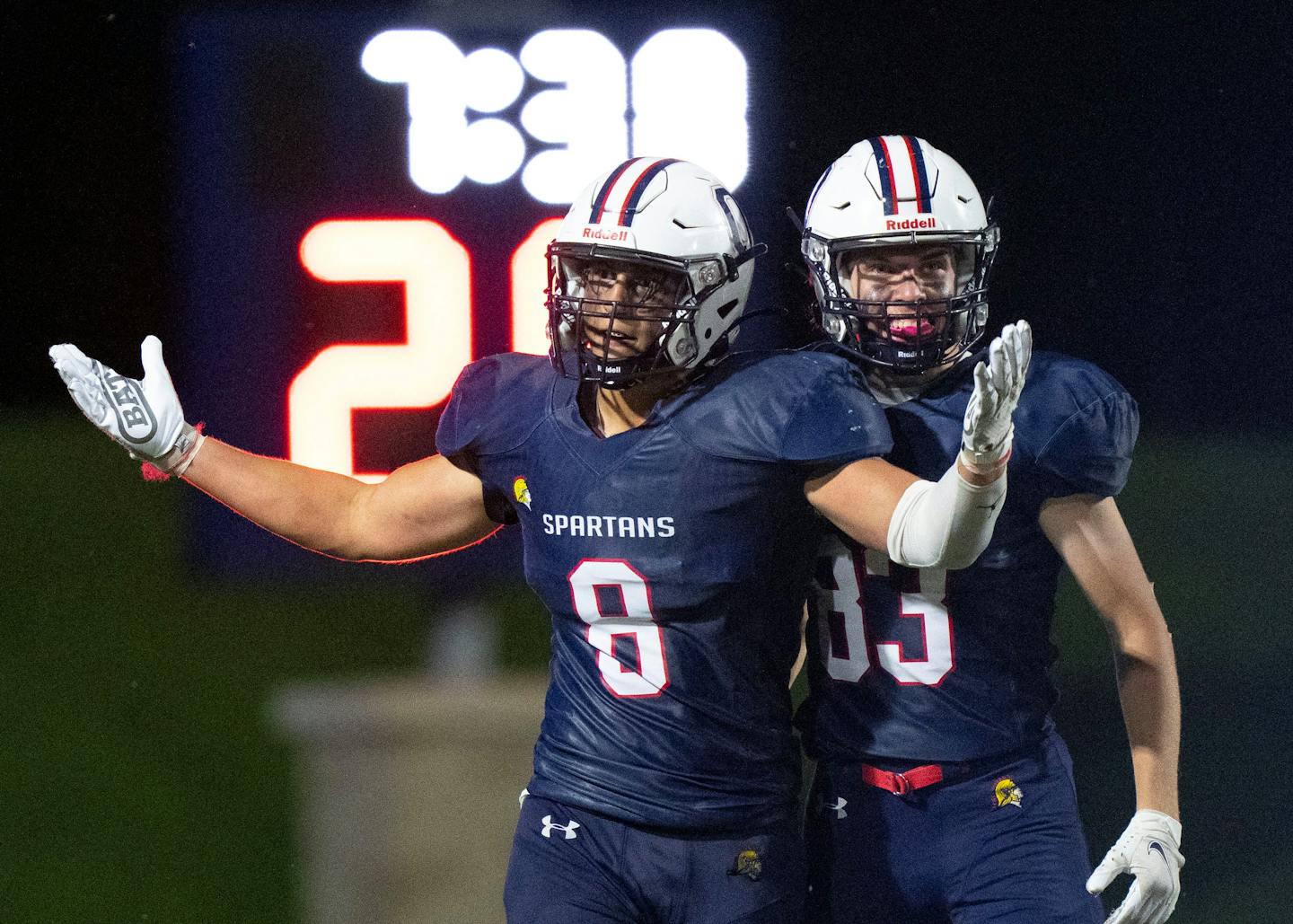 Orono linebacker Nash Tichy (8) celebrates with Hunter Fox (83) after scoring a long touchdown in the fourth quarter against Robbinsdale Cooper Friday, Sept. 2, 2022 at Orono High School in Orono, Minn. Orono would go on to win 21-18. ]