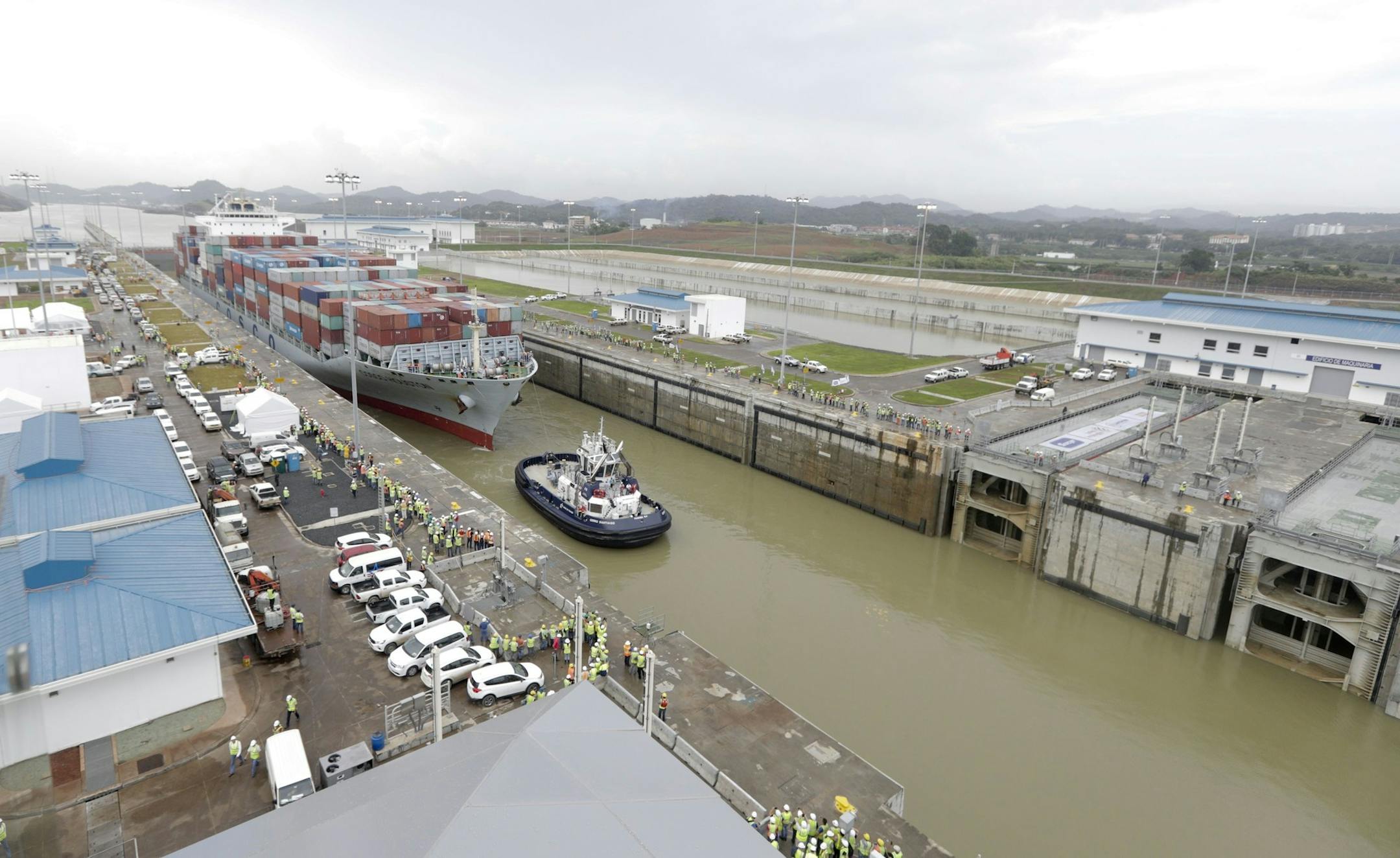 A Panamax cargo vessel, navigates the new Cocoli locks during a test of the expanded Panama Canal locks on Pacific side, in Panama, Thursday, June 23, 2016. The ship, the largest that can go through the old canal locks was redirected to the new ones for one more test of the new lock system. The $5.25 billion expansion of the Panama canal is set to open Sunday at a difficult moment for the international commercial shipping market. (AP Photo/Arnulfo Franco)