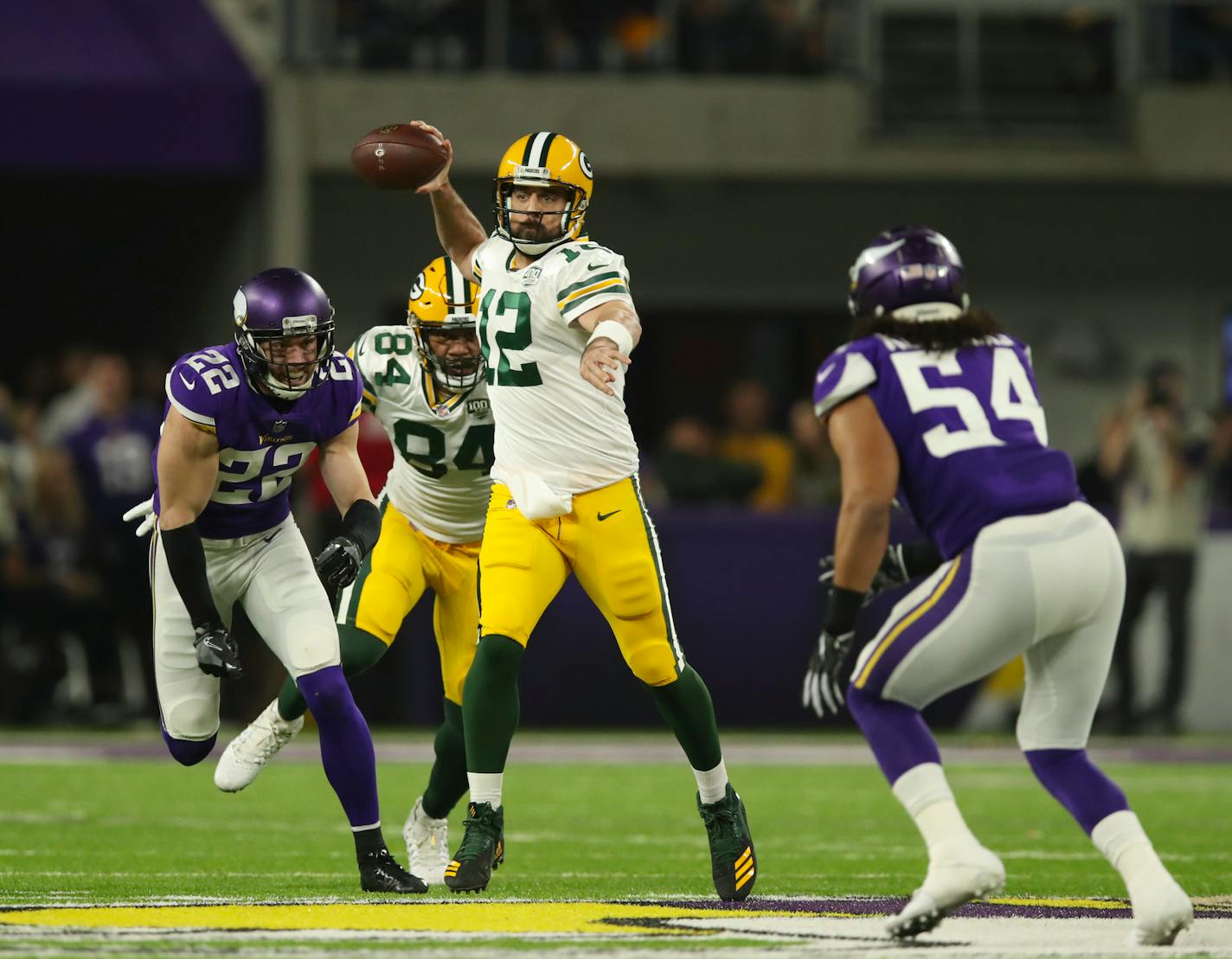 Packers quarterback Aaron Rodgers looked for a receiver in the first quarter with Vikings safety Harrison Smith in pursuit