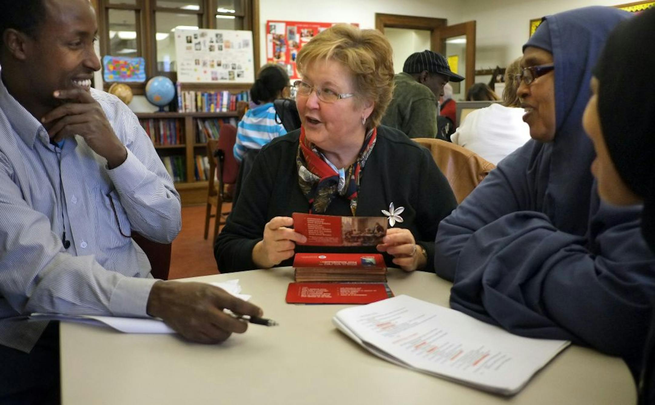 Jill Seinola, center, tutored Abdifatah Hassan, left, Hodan Dahir and Qadan Ashur in civics.