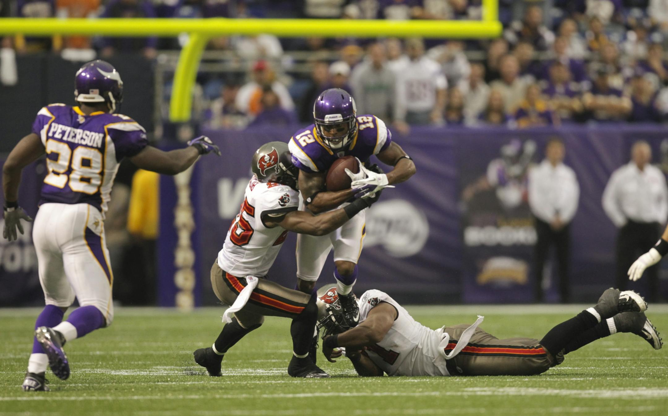 On the last play of the game, Percy Harvin carried the ball after receiving a lateral from teammate Adrian Peterson, left.