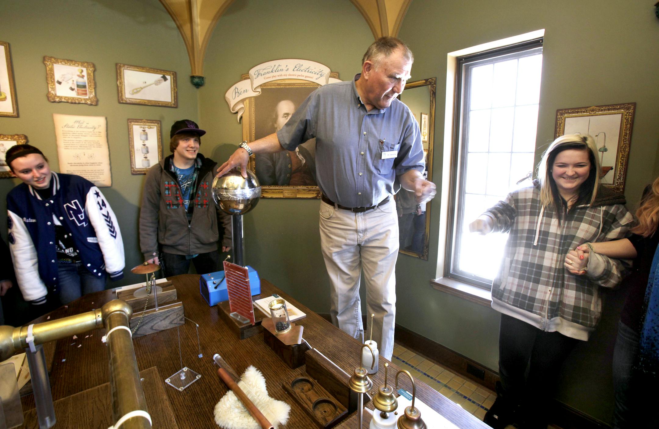 Richard Johnson, (center) a volunteer at the Bakken Museum, shows students Autumn Percy (left blue jcacket), Spencer Stanley, and Kelsey Baeten (plaid jacket) of North Oaks Academy in Forest Lake a experiment on static electricity at the Bakken Museum located at 3537 Zenith Avenue South in Minneapolis, MN 55416 on April 1, 2013. ] JOELKOYAMA&#x201a;&#xc4;&#xa2;joel koyama@startribune.com Richard Johnson, a volunteer I'm profiling, will be showing students throuh the Bakken Museum.