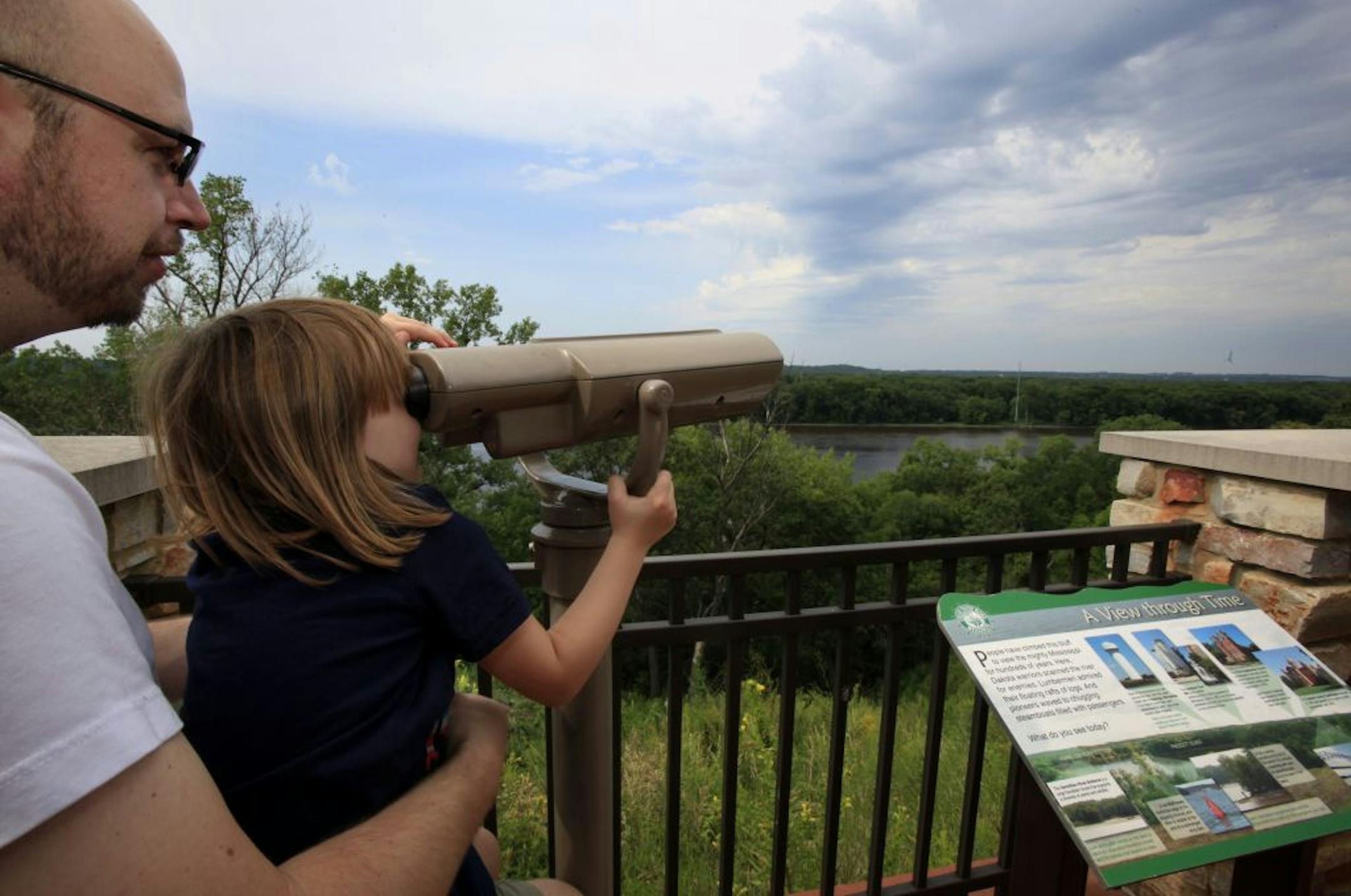 David Rohl and his daughter Lola Rohl ( 4 years old) of Prescott, Wisconsin visit the NPS visitor's center many mornings in the summer to enjoy the outdoor park and all the exhibits indoors. Today they used the binoculars to look at the city of Hastings, MN and watch as the eagles fly around the visitors center. October 1, 2012.