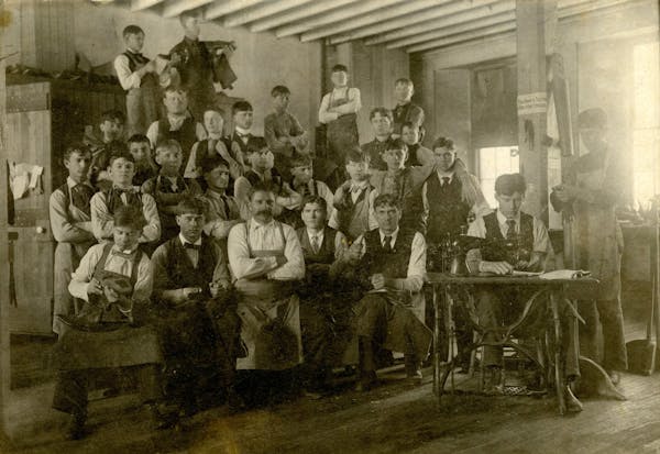 Students in a shoemaking class in Faribault posed for a photo in the 1890s. This photograph was likely taken at the school for the deaf.