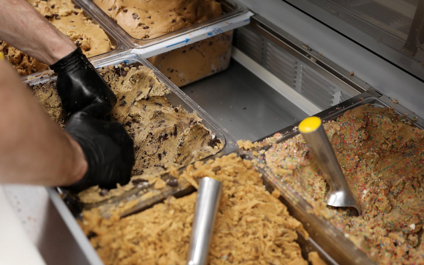 Workers dished out cookie dough on the Dough Dough food truck Wednesday in downtown Minneapolis. ] ANTHONY SOUFFLE &#xef; anthony.souffle@startribune.com Dough Dough food truck has become a craze, drawing long lines as it sat parked Wednesday, May 24, 2017 in downtown Minneapolis.