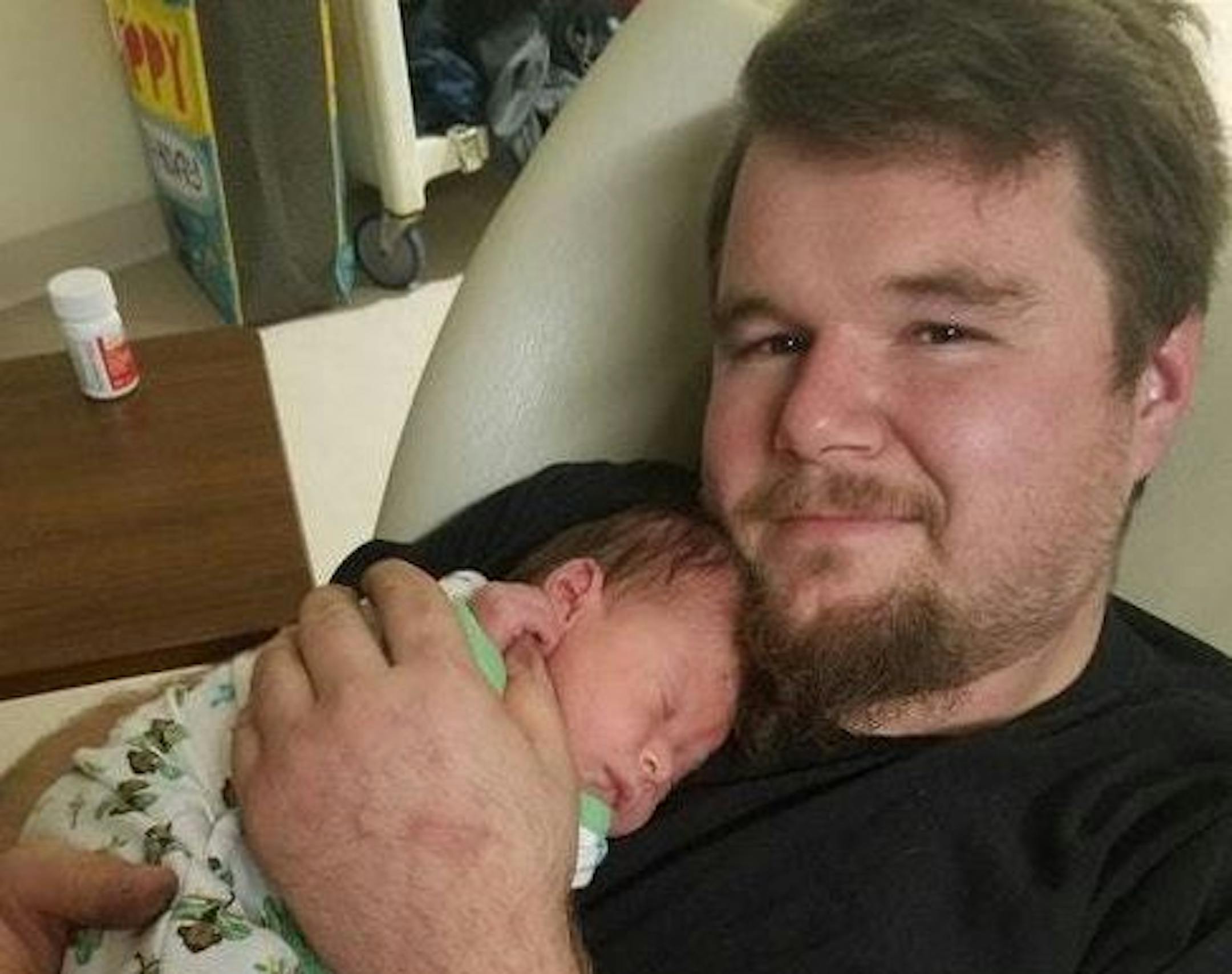 David R. Ryman, with his third child shortly before he was killed.