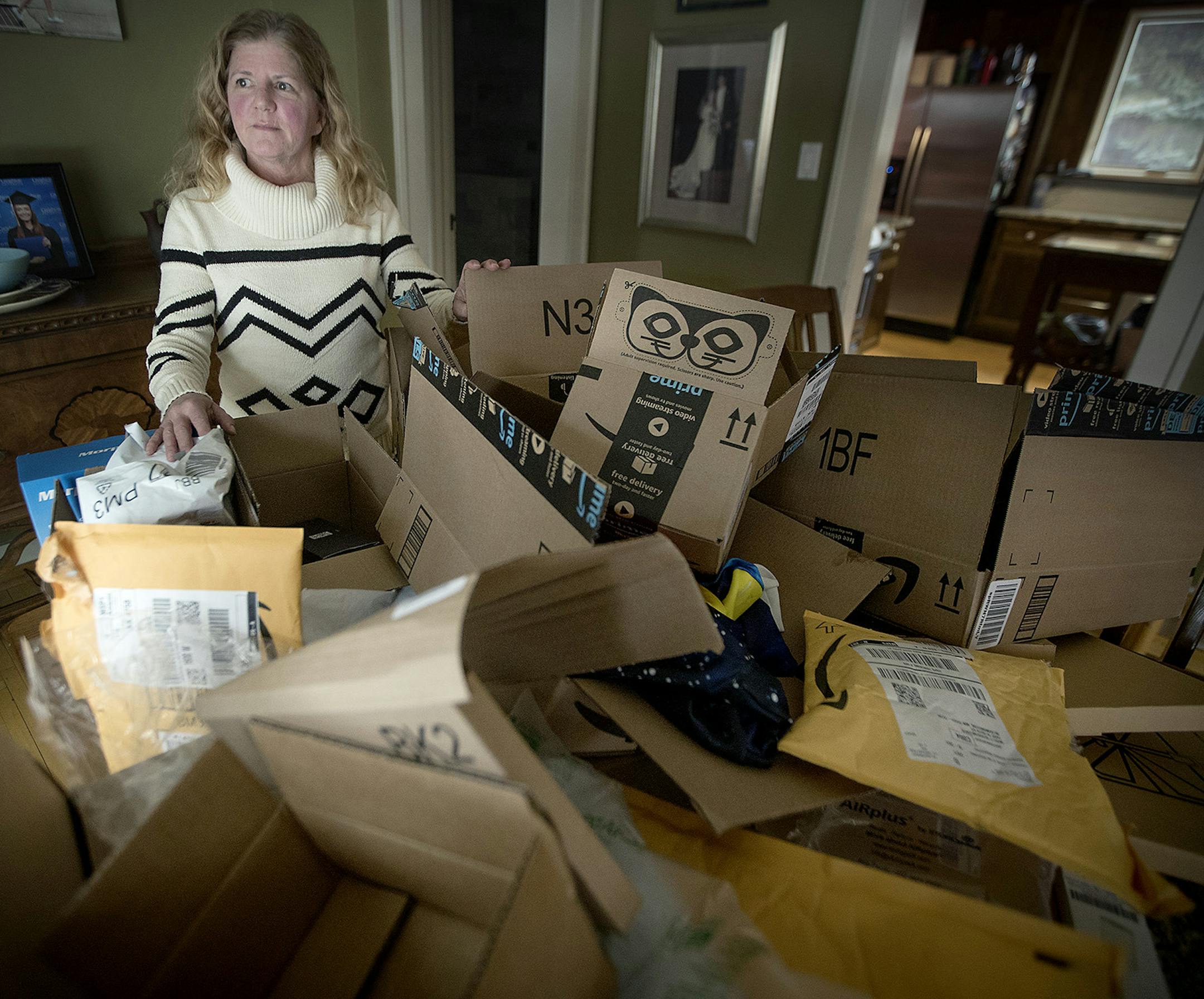 Liz Schoenecker, who stood before a sea of Amazon packages, shared that she became worried and contacted the police after her daughter kept receiving the unwanted and unordered Amazon packages to her home, Tuesday, February 13, 2018 in Bloomington, MN. ] ELIZABETH FLORES • liz.flores@startribune.com
