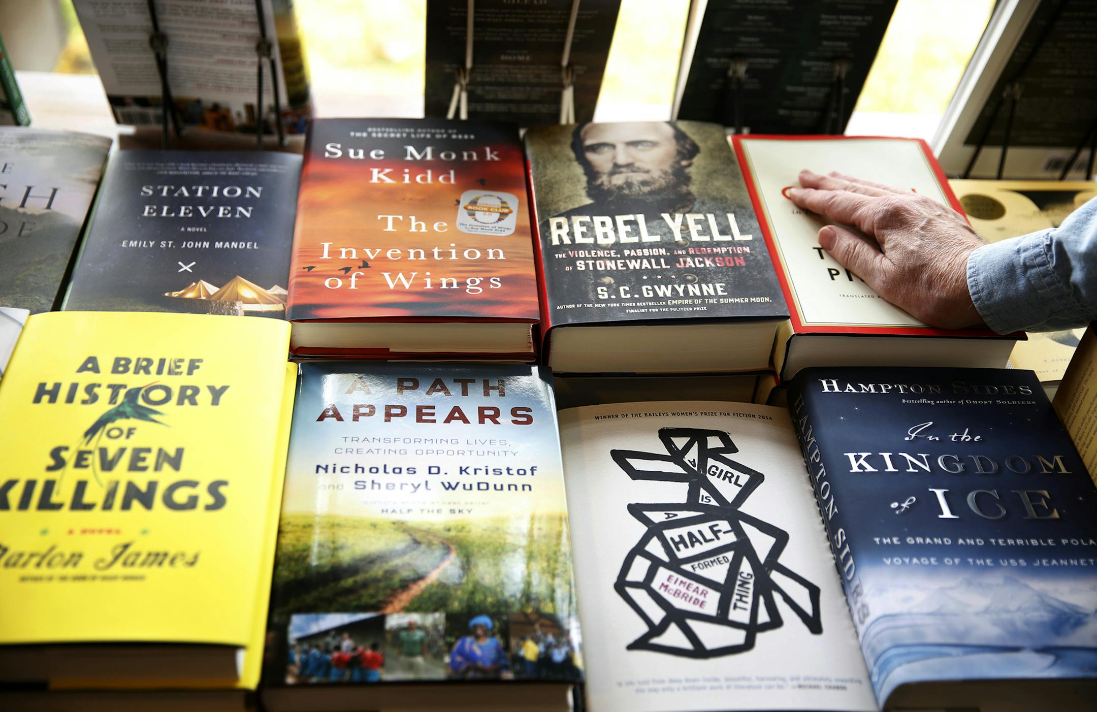 Tom Bielenberg, owner of Micawbers Books in the St. Anthony Park neighborhood of St. Paul, tidies one of his displays. ] LEILA NAVIDI leila.navidi@startribune.com / BACKGROUND INFORMATION: Wednesday, October 22, 2014. Micawbers is a longtime independent neighborhood bookseller trying to survive in the age of online competition and big box retailers.
