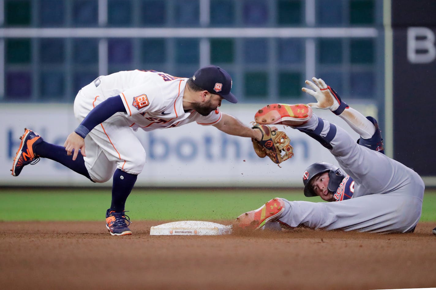 Houston Astros second baseman Jose Altuve, left, tags out Minnesota Twins' Jose Miranda, right, during the sixth inning of a baseball game Thursday, Aug. 25, 2022, in Houston. (AP Photo/Michael Wyke)