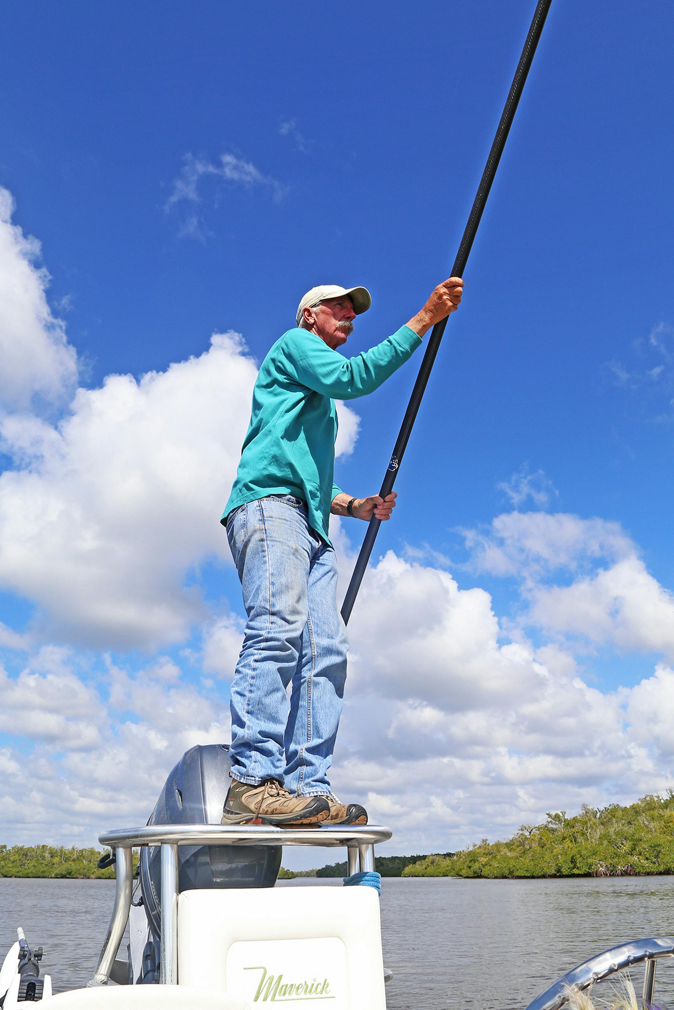 Florida fishing guide Ned Small on the poling platform of his skiff. From his perch he moves the boat slowly and silently, positioning the angler on the bow of the boat to cast to redfish or snook.