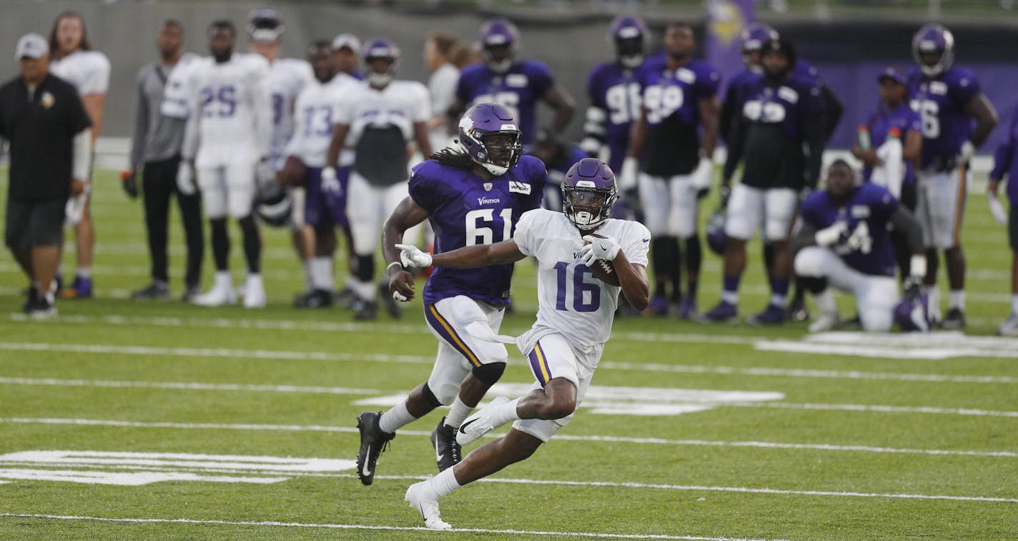 Minnesota Vikings wide receiver Cayleb Jones (16) avoids the tackle of defensive end Ade Aruna (61) at a night practice during training camp at TCO Performance Center in Eagan, Minn., on Saturday, Aug. 4, 2018. (Jerry Holt/Minneapolis Star Tribune/TNS)