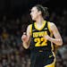 Iowa guard Caitlin Clark (22) stands on the court during the first half of an NCAA college basketball game against Minnesota, Wednesday, Feb. 28, 2024