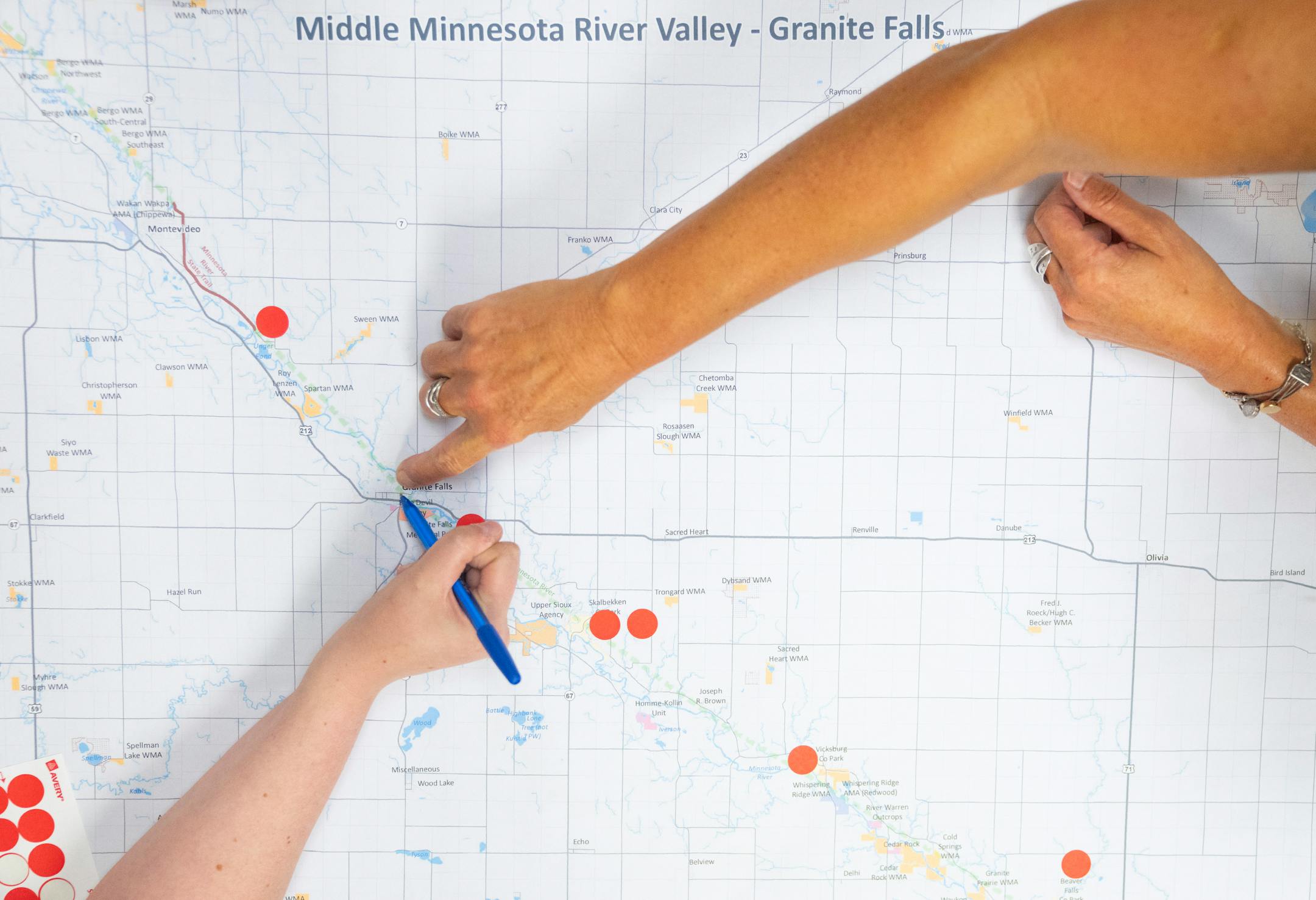 Crystal Johnson and Lisa Streich, left to right, work on marking a map with areas they like to recreate in the Minnesota River Valley during a DNR public engagement meeting at Kilowatt Community Center.