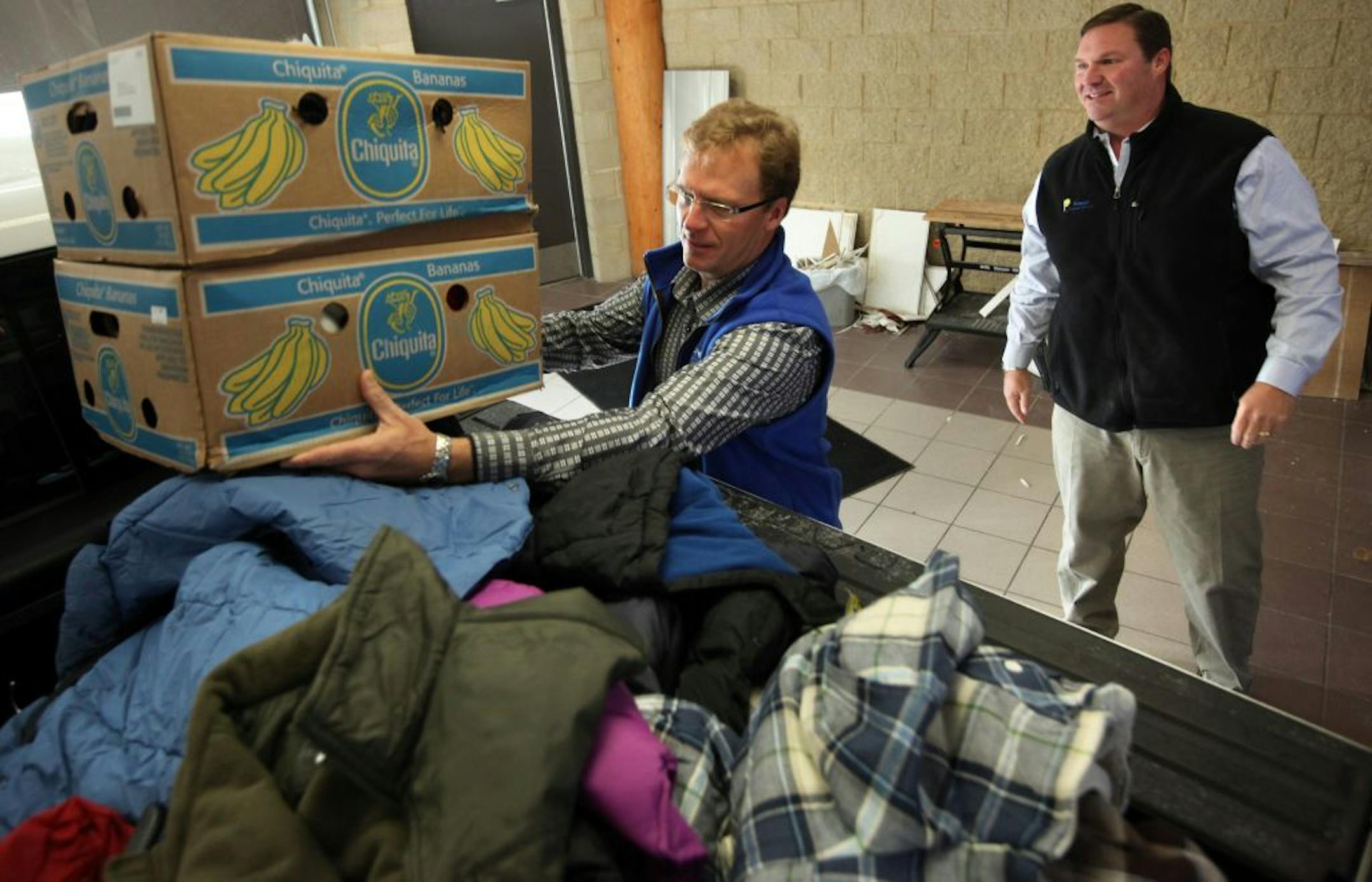 Eric Wenzel started a winter coat drive last year with two drop boxes and a simple idea to pay back a community that supported him during his fight with cancer. This year the effort has grown so big that Coats of Kindness had more than a dozen drop sites in the metro area. Here, Eric Wenzel (right) is helped load coates into his truck by friend Tom Leonard at Fury Motors in S. St. Paul.