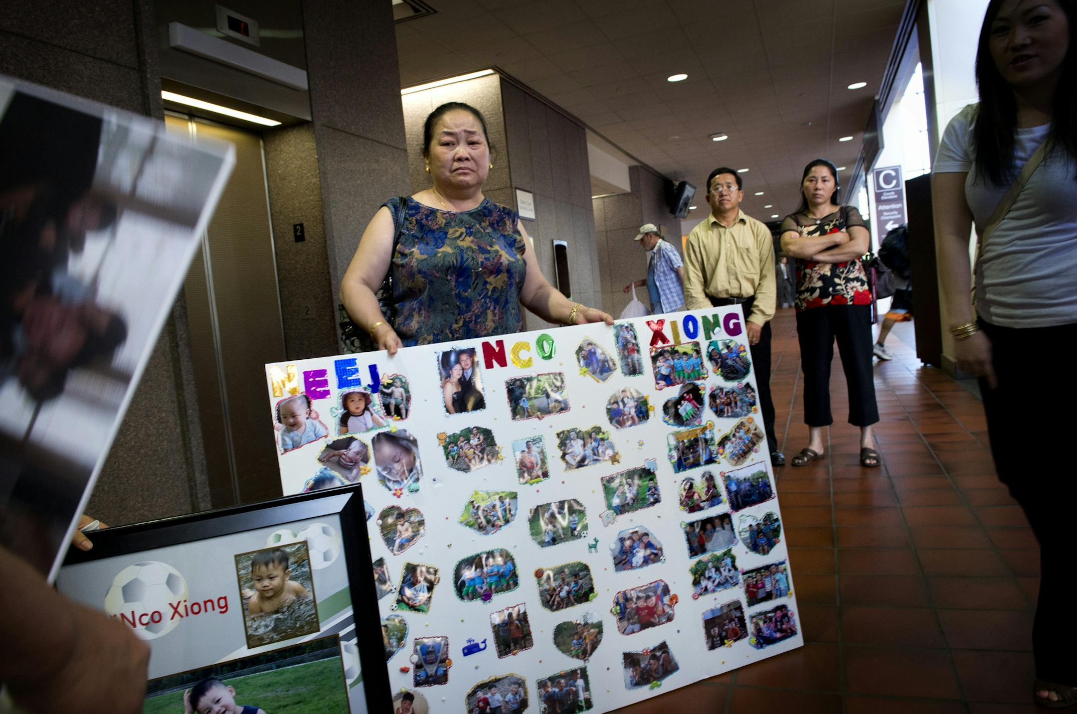 Kao's mother Lori Vang tearfully held photos of her dead grandson Neegnco Xiong after the sentencing of her son. Kao Xiong, whose 4-year-old son shot and killed his little brother with an unsecured handgun, was sentenced Thursday morning to 10 years’ probation and 30 days in jail.Thursday, June 27, 2013. ] GLEN STUBBE * gstubbe@startribune.com