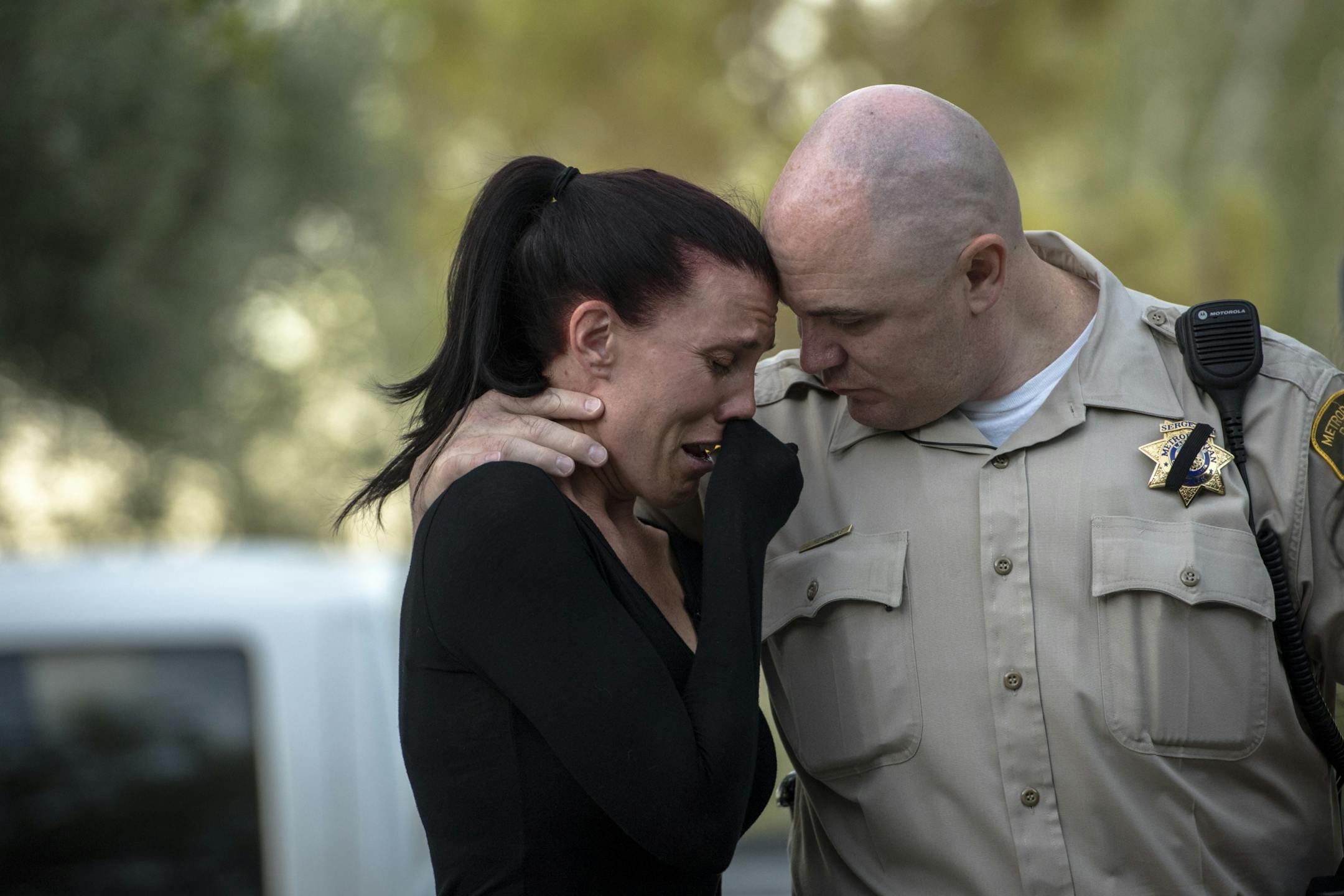 A Las Vegas Metropolitan Police officer comforts a woman before a vigil at Mountain Crest Park following the mass shooting in Las Vegas, Oct. 3, 2017. A lone gunman, identified as Stephen Paddock, fired down from a 32nd-floor suite at the Mandalay Bay Resort and Casino upon a crowded country music festival on Sunday night, killing at least 59 and injuring more than 500.