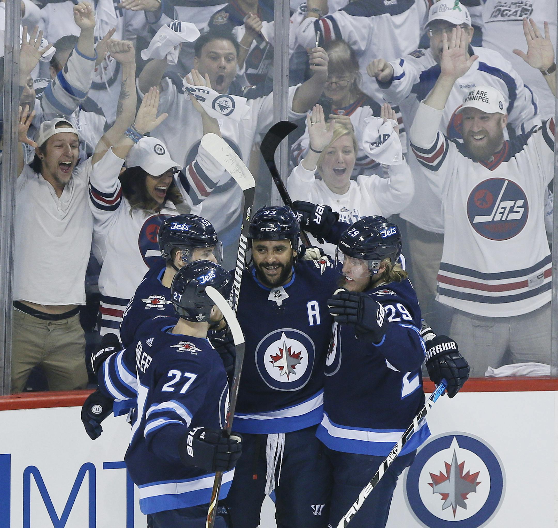 Winnipeg Jets' Nikolaj Ehlers (27), Mark Scheifele (55), Dustin Byfuglien (33) and Patrik Laine (29) celebrate Byfuglien's goal against the Vegas Golden Knights during the first period of Game 1 of the NHL hockey playoffs Western Conference final, Saturday, May 12, 2108, in Winnipeg, Manitoba. (John Woods/The Canadian Press via AP)