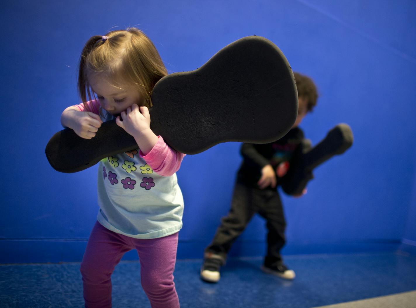 Grace Schumacher, almost age 2, of Stillwater, pretended to play guitar on a rock-star stage where children can watch themselves light up on a video screen at the science of Museum in St. Paul, Minn., on Friday, April 12, 2013. ] (RENEE JONES SCHNEIDER * reneejones@startribune.com)