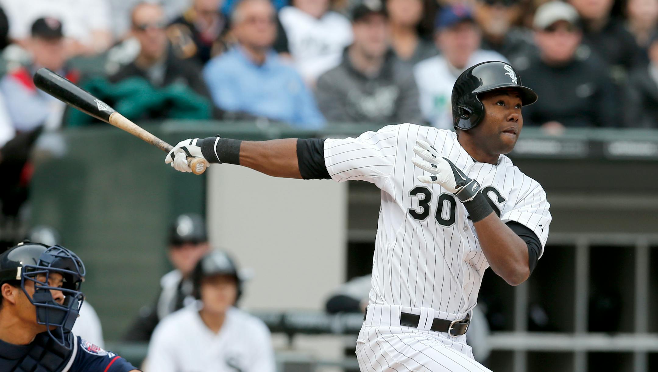 Chicago White Sox's Alejandro De Aza (30) watches his two run home run off Minnesota Twins starting pitcher Ricky Nolasco, also scoring Jose Abreu, during the second inning of an Opening Day baseball game Monday, March 31, 2014, in Chicago.