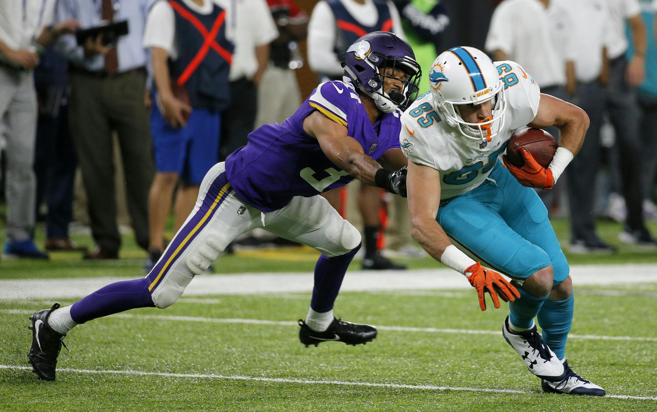 Miami Dolphins wide receiver Mitch Mathews (85) breaks a tackle by Minnesota Vikings cornerback Sam Brown, left, on a touchdown reception during the second half of an NFL preseason football game, Thursday, Aug. 31, 2017, in Minneapolis. (AP Photo/Bruce Kluckhohn)