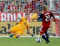 Vito Mannone dives to block a shot attempt by FC Dallas's Michael Barrios during the first half