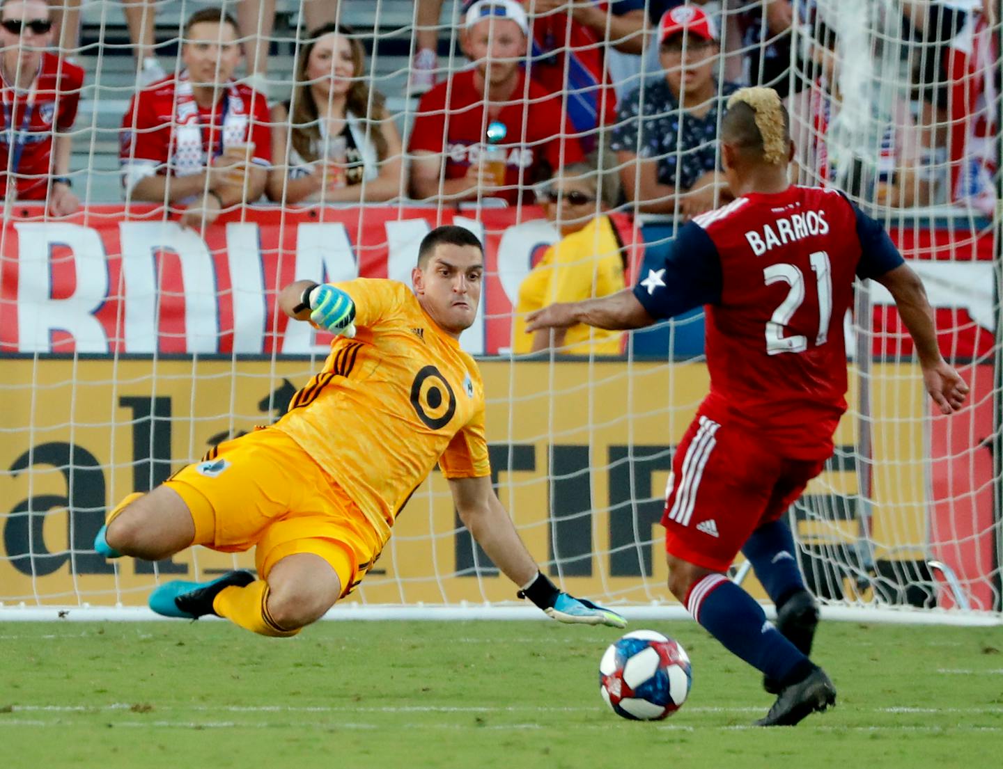 Vito Mannone dives to block a shot attempt by FC Dallas's Michael Barrios during the first half