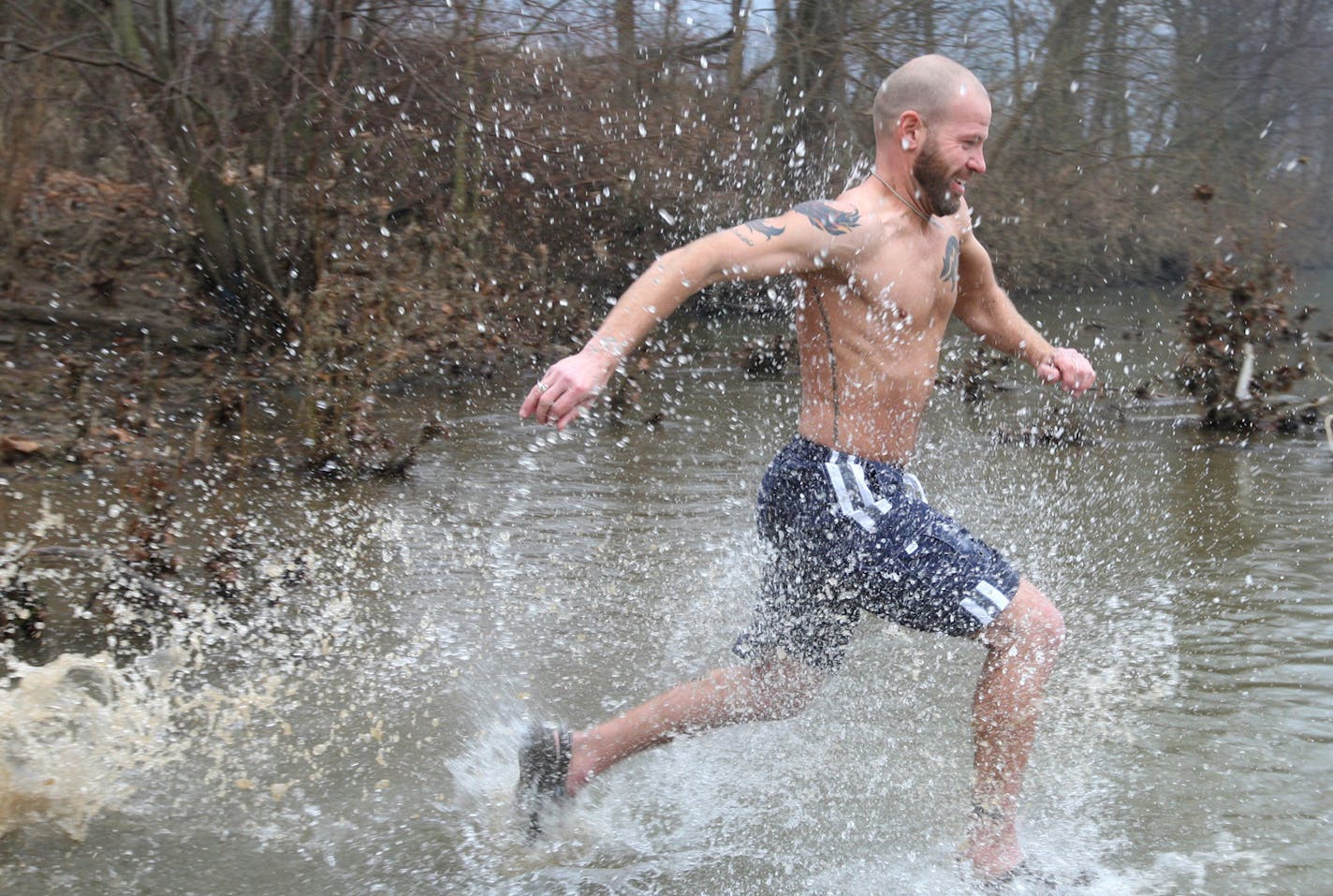 T. Grant Lewis of Winchester, Va., runs into the frigid water of the Shenandoah River in Bluemont, Va., Sunday, March 2, 2014, during the "Polar Plunge for Kids at Risk" fundraiser. The event raises funds to send underprivileged children to summer camp. (AP Photo/The Winchester Star, Jeff Taylor) ORG XMIT: VAWIN102