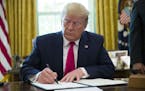 President Donald Trump signs an executive order to increase sanctions on Iran, in the Oval Office of the White House, Monday, June 24, 2019, in Washin