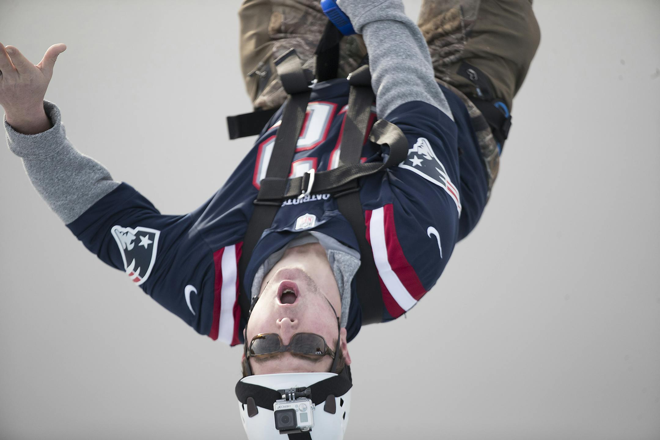 Sporting a Patriots jersey, Paul Studer of Minnetonka made his way across the Mississippi River via zip line, Friday, January 26, 2018 in Minneapolis, MN. ] ELIZABETH FLORES ï liz.flores@startribune.com