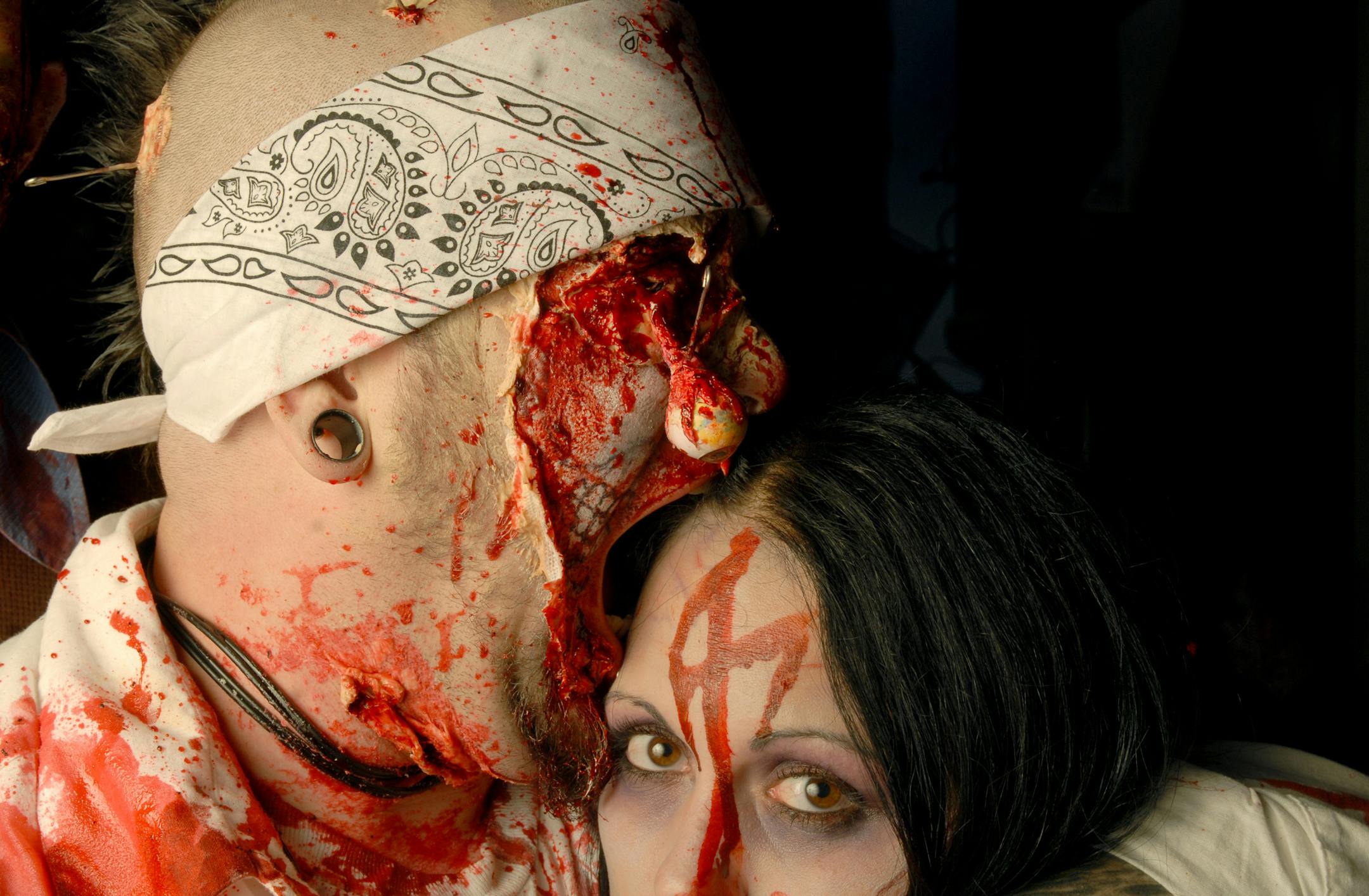 Travis Daugherty, left, bites into Amanda Clausen on Saturday, Oct. 18, 2008, at the Zombie Pub Crawl in Minneapolis.