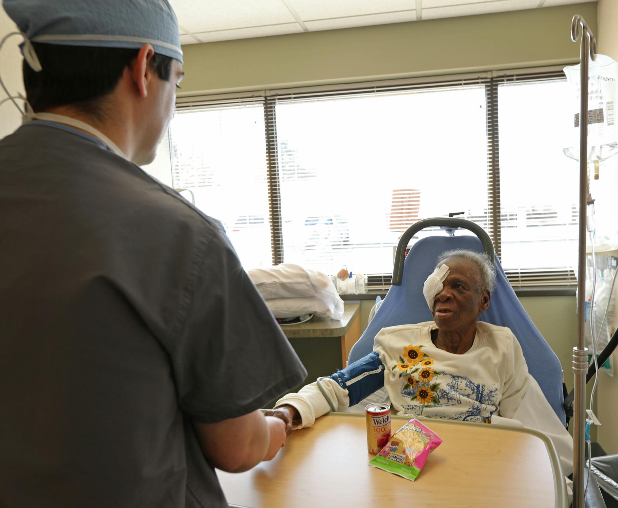 Florence Odujole held the hand of Dr. Walter Parker as she thanked and prayed for him after her cataract removal procedure.
