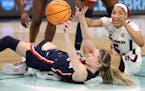 UConn guard Paige Bueckers passed under pressure from South Carolina forward Victaria Saxton during Sunday's championship game at Target Center.