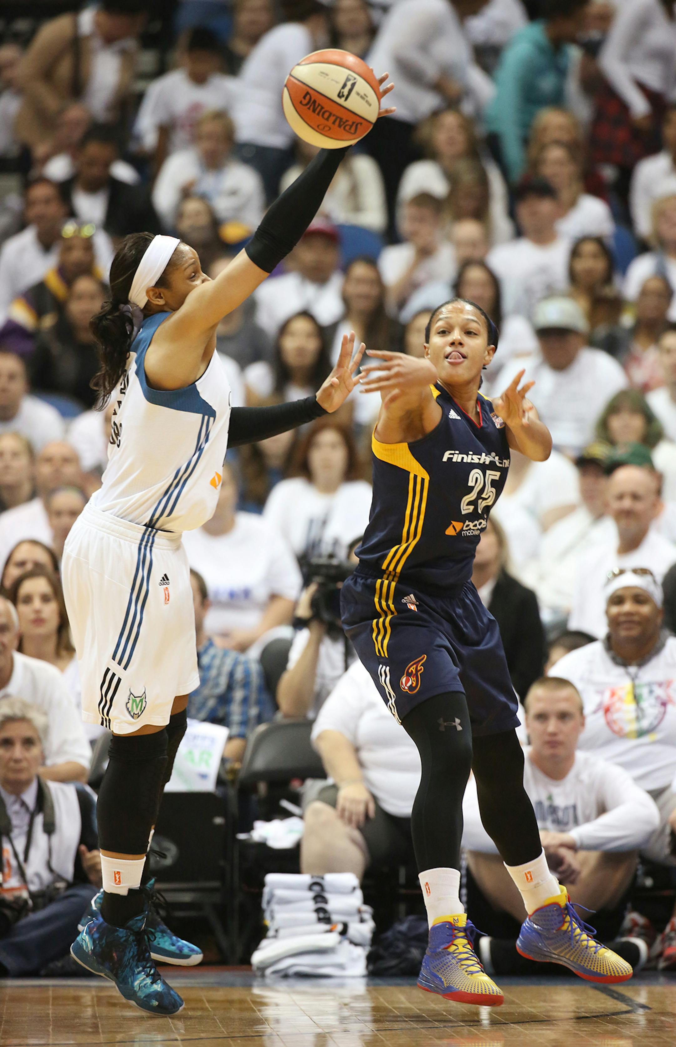 Indiana Fever guard Marissa Coleman (25) passes the ball past Minnesota Lynx forward Maya Moore (23) during the first quarter.