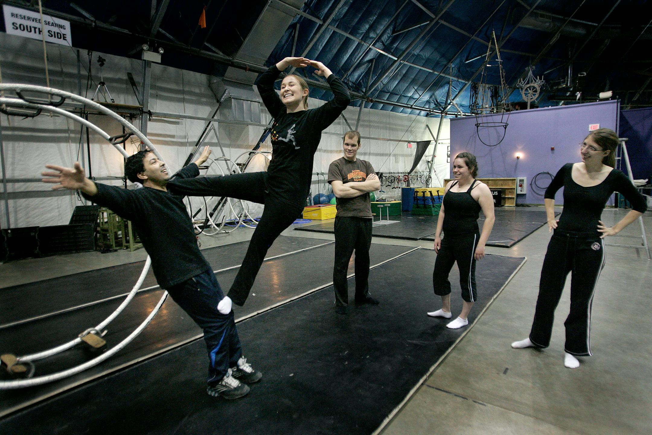 Andrea Guggenbuehl, a teaching assistant, learned how to make a human pyramid with the help of Circus Juventas coach Mostapha Hassouni, left. Classmates Brandon Turek-Knengel, Rachel Willenbring and Carly Olin are also St. Thomas engineering students studying the force of dynamics through circus acrobatics.