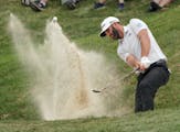 Second round coverage of the 3M Open - Dustin Johnson hits his second chip shot out of the bunker just off the 9th green.