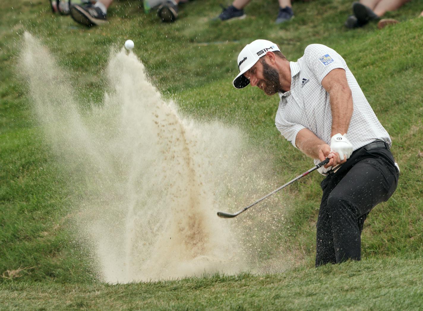 Second round coverage of the 3M Open - Dustin Johnson hits his second chip shot out of the bunker just off the 9th green.