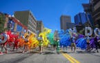Inflated balloons spelling "Orlando" are followed by an array of inflated balloons that created a rainbow at the Twin Cities Pride parade on Sunday in
