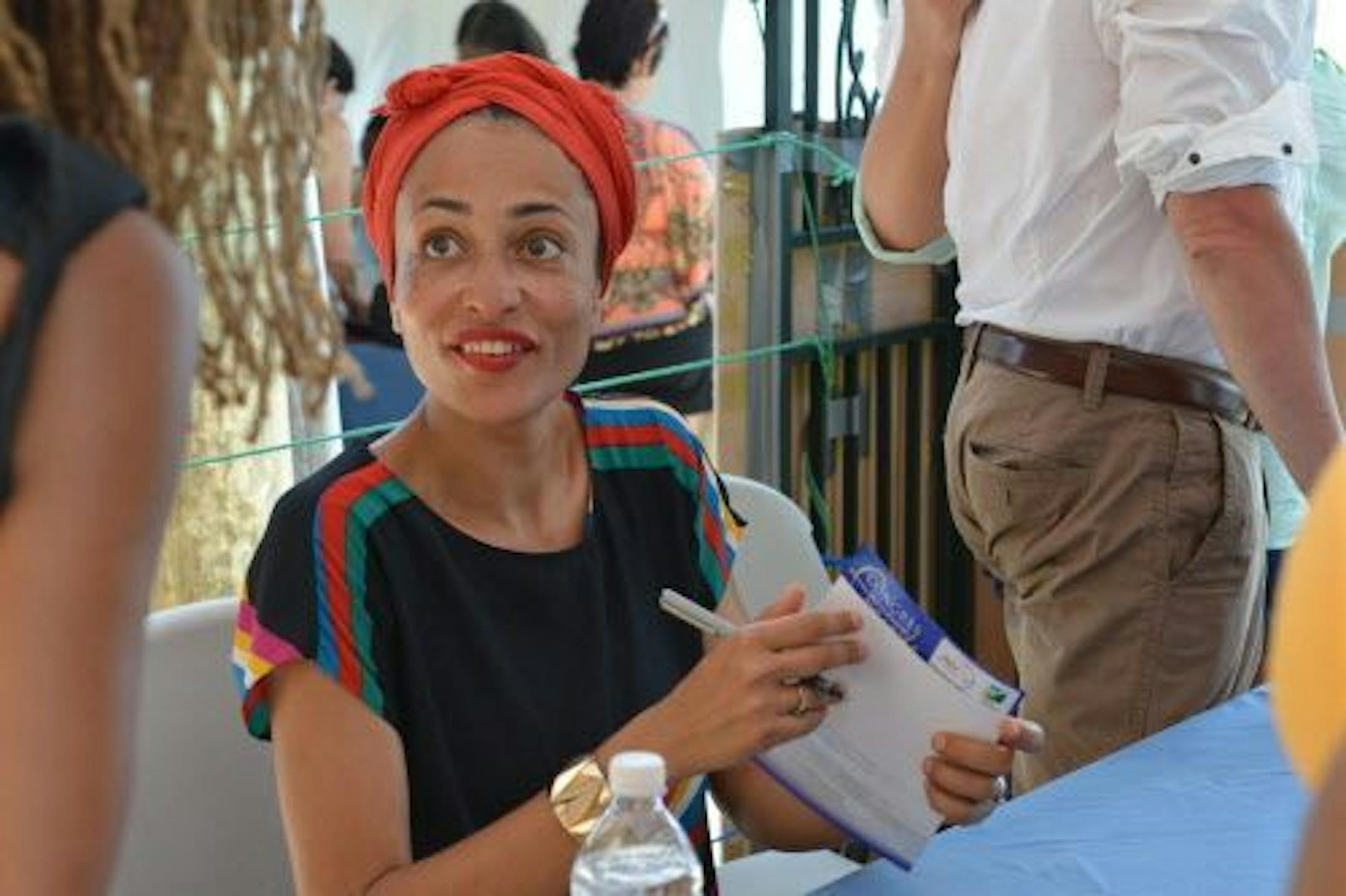 Acclaimed novelist Zadie Smith is shown signing a book for a fan in Treasure Beach, Jamaica, Saturday, May 31, 2014.