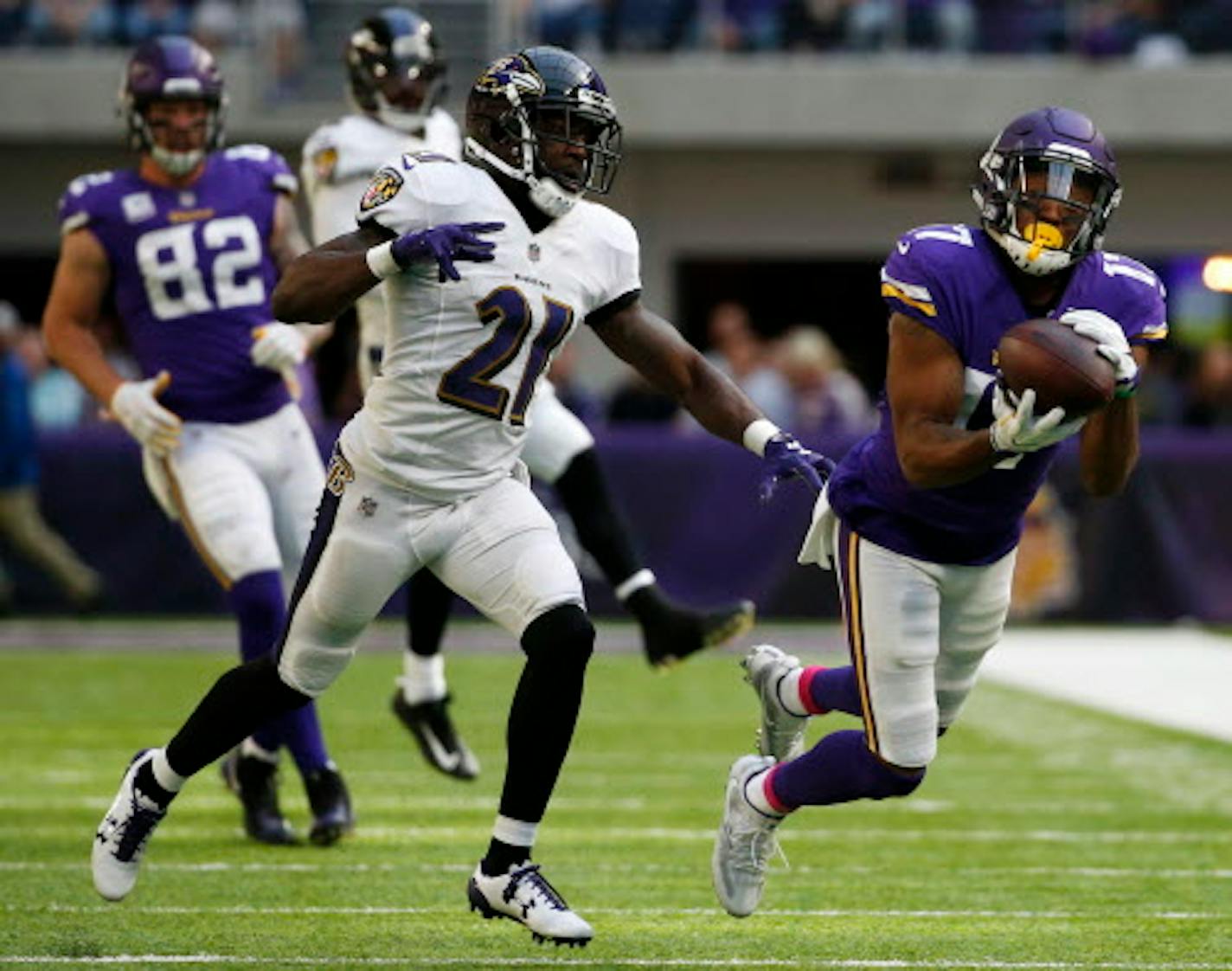 Minnesota Vikings wide receiver Jarius Wright catches a pass ahead of Baltimore Ravens free safety Lardarius Webb (21) during the second half of an NFL football game, Sunday, Oct. 22, 2017, in Minneapolis.  (AP Photo/Bruce Kluckhohn)