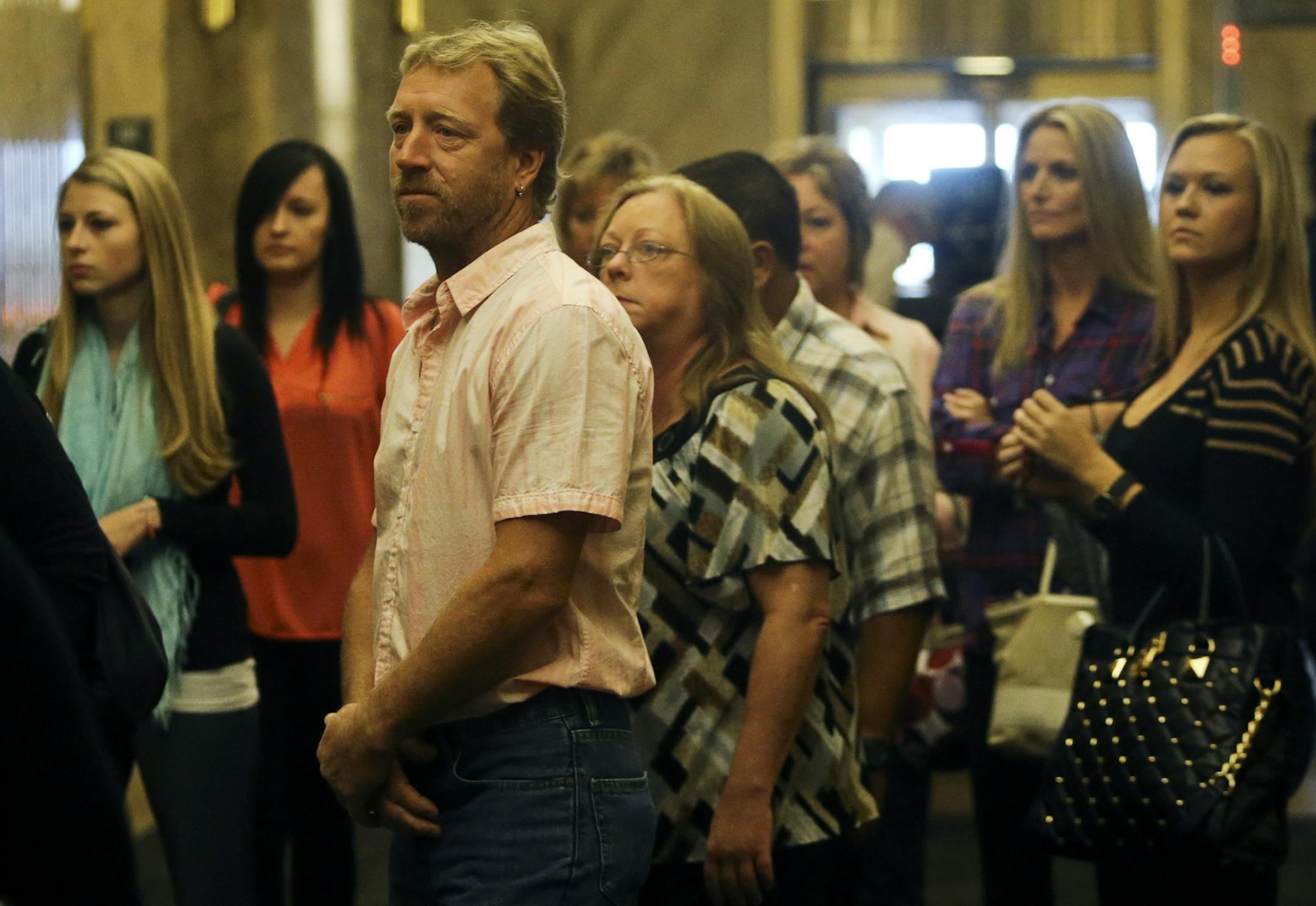 In this Sept. 19 file photo, Kira Steger's parents Jay Steger and Marcie Steger, center left and right, wait for an elevator before heading to the courtroom for the start of the murder trial of Jeffrey Trevino, Kira's husband, at the Ramsey County Courthouse in St. Paul.