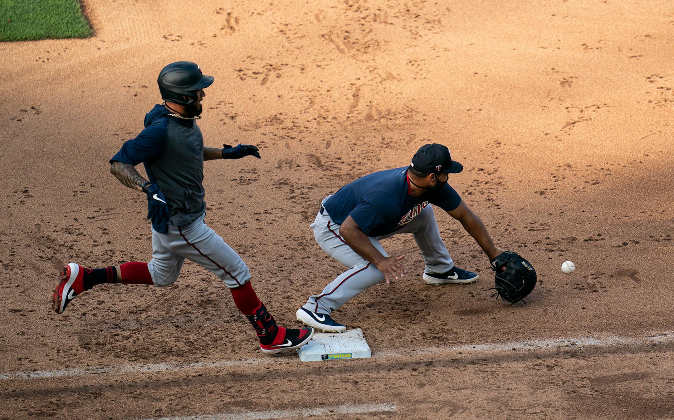 Minnesota Twins right fielder Eddie Rosario (20) ran safely to first as Tom�s Telis tried to get him out at first during a scrimmage at practice at Target Field in Minneapolis, Minn., on Wednesday, July 8, 2020.
