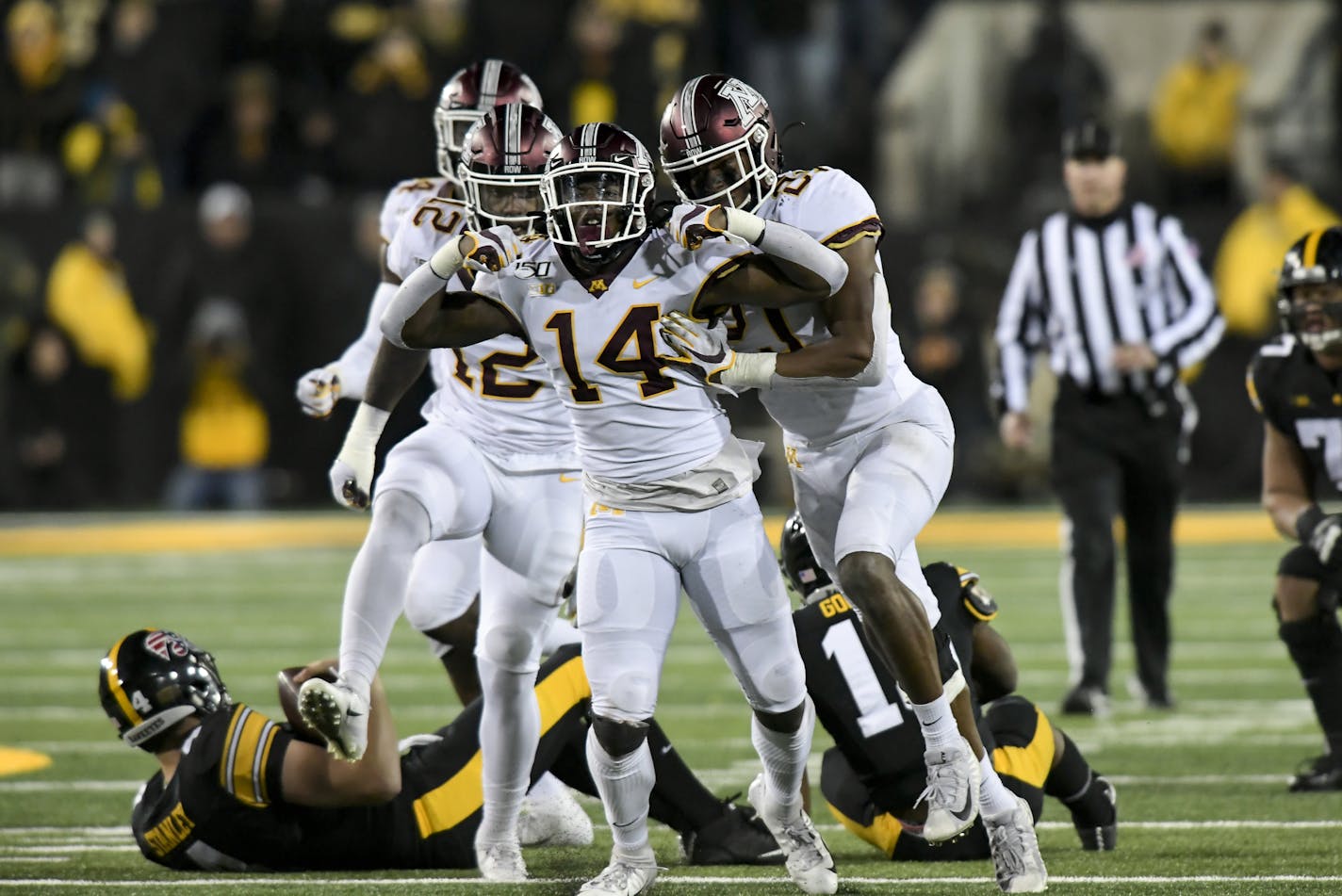 Minnesota Gophers linebacker Kamal Martin (21), linebacker Braelen Oliver (14) and defensive lineman Tai'yon Devers (12) celebrated a sack by Oliver in the fourth quarter against Iowa Hawkeyes quarterback Nate Stanley (4). ] Aaron Lavinsky &#x2022; aaron.lavinsky@startribune.com The Minnesota Gophers played the Iowa Hawkeyes on Saturday, Nov. 16, 2019 at Kinnick Stadium in Iowa City, IA.