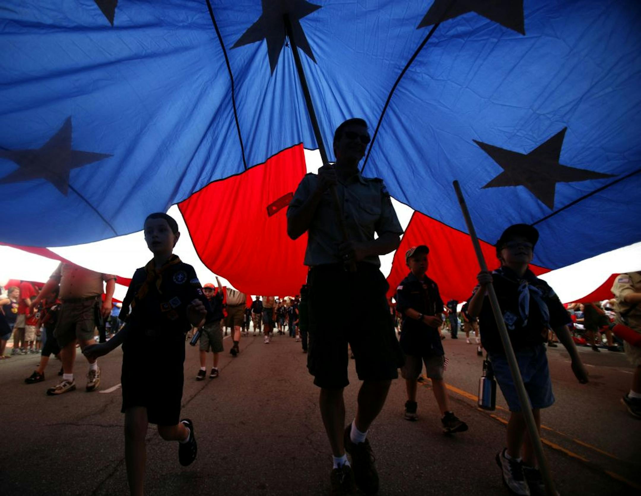 Boy Scouts of America and Cub Scout troops carry a large American flag during the LibertyFest Fourth of July parade in Edmond, Okla., Monday, July 4, 2011.